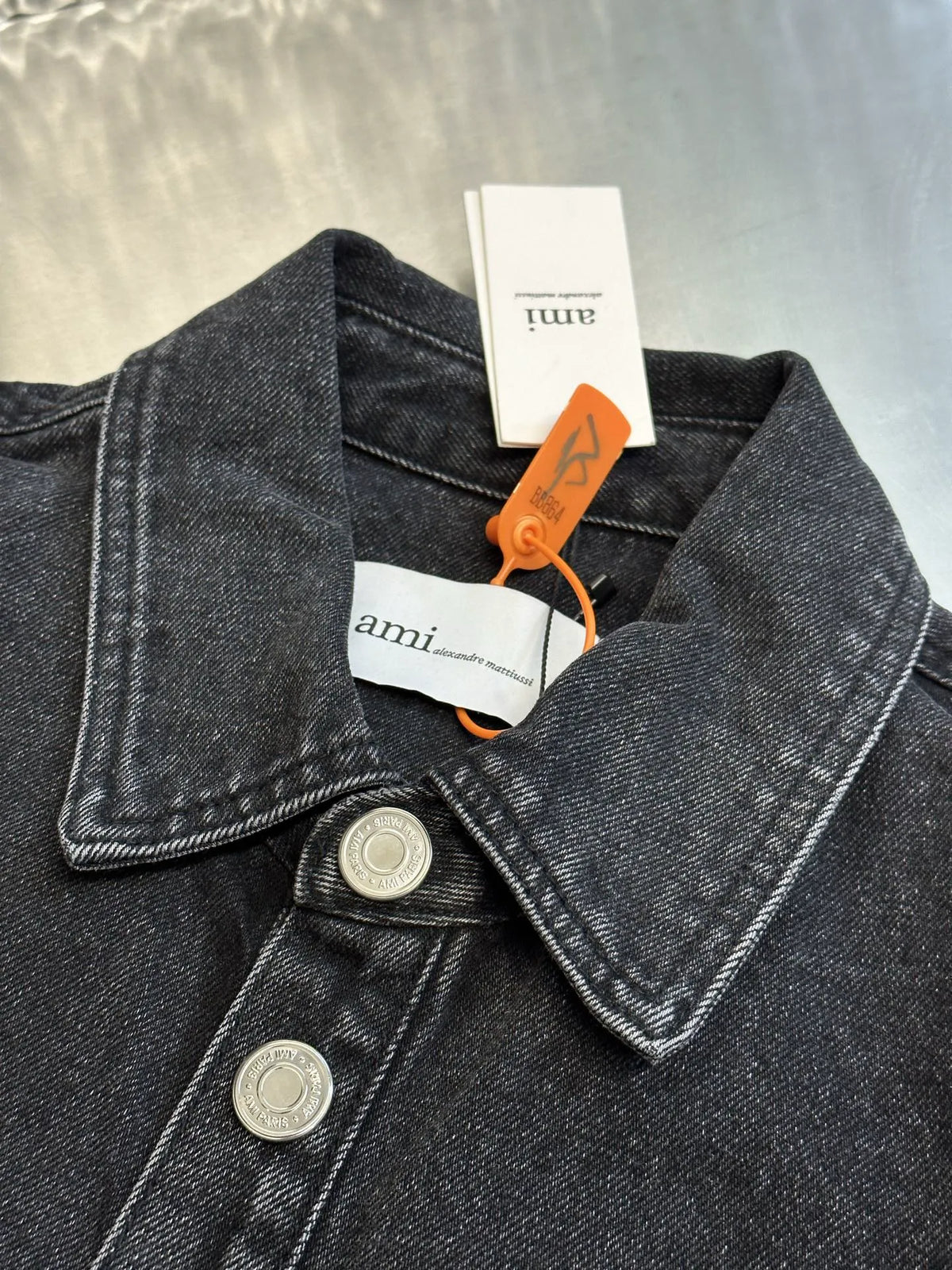 Dark blue denim jacket close-up of pointed collar and metal snap buttons