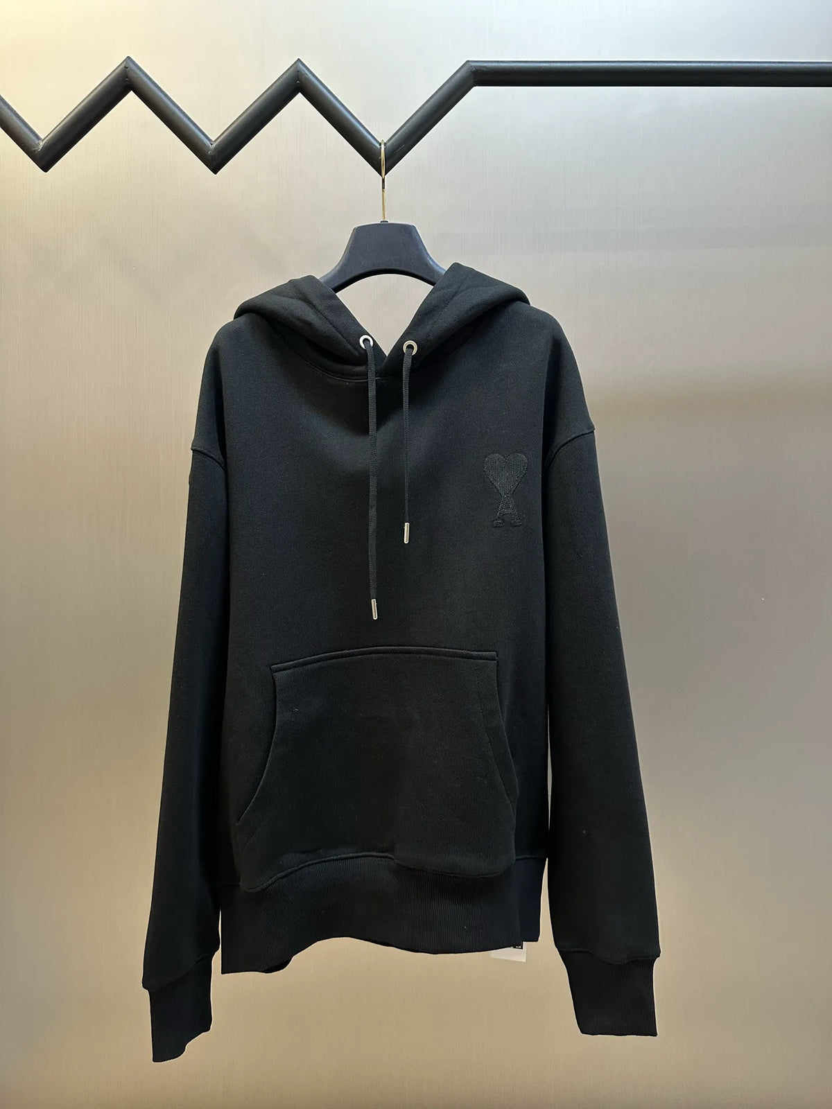 Black zip-up hoodie with drawstring hood and front kangaroo pocket