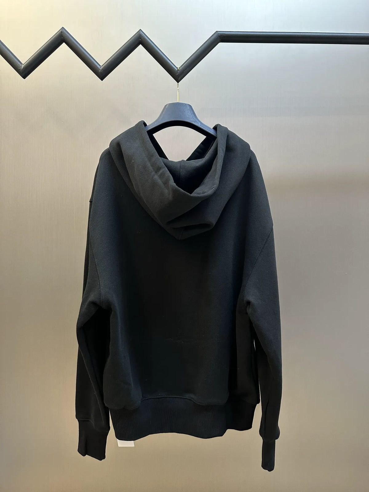 Black pullover hoodie with cowl hood and front kangaroo pocket