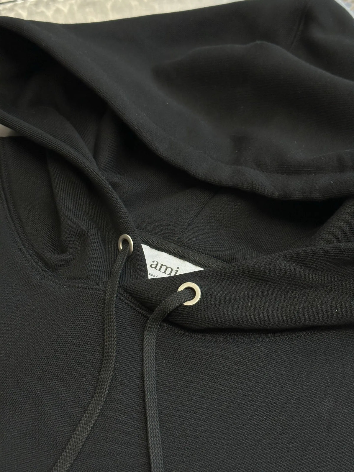 Black hoodie chest area with drawstring and kangaroo pocket opening