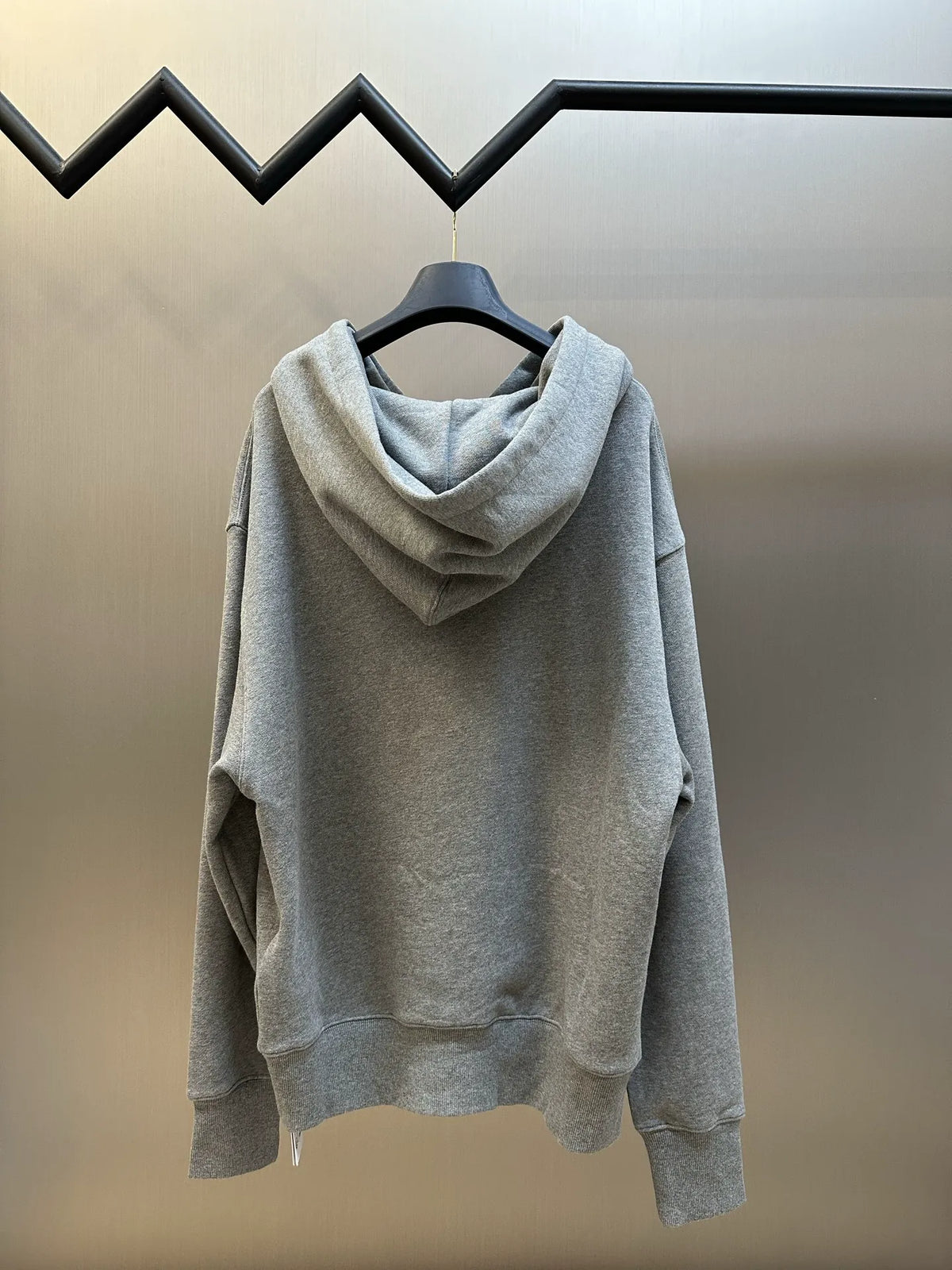 Gray long-sleeve hoodie on hanger, hooded pullover style