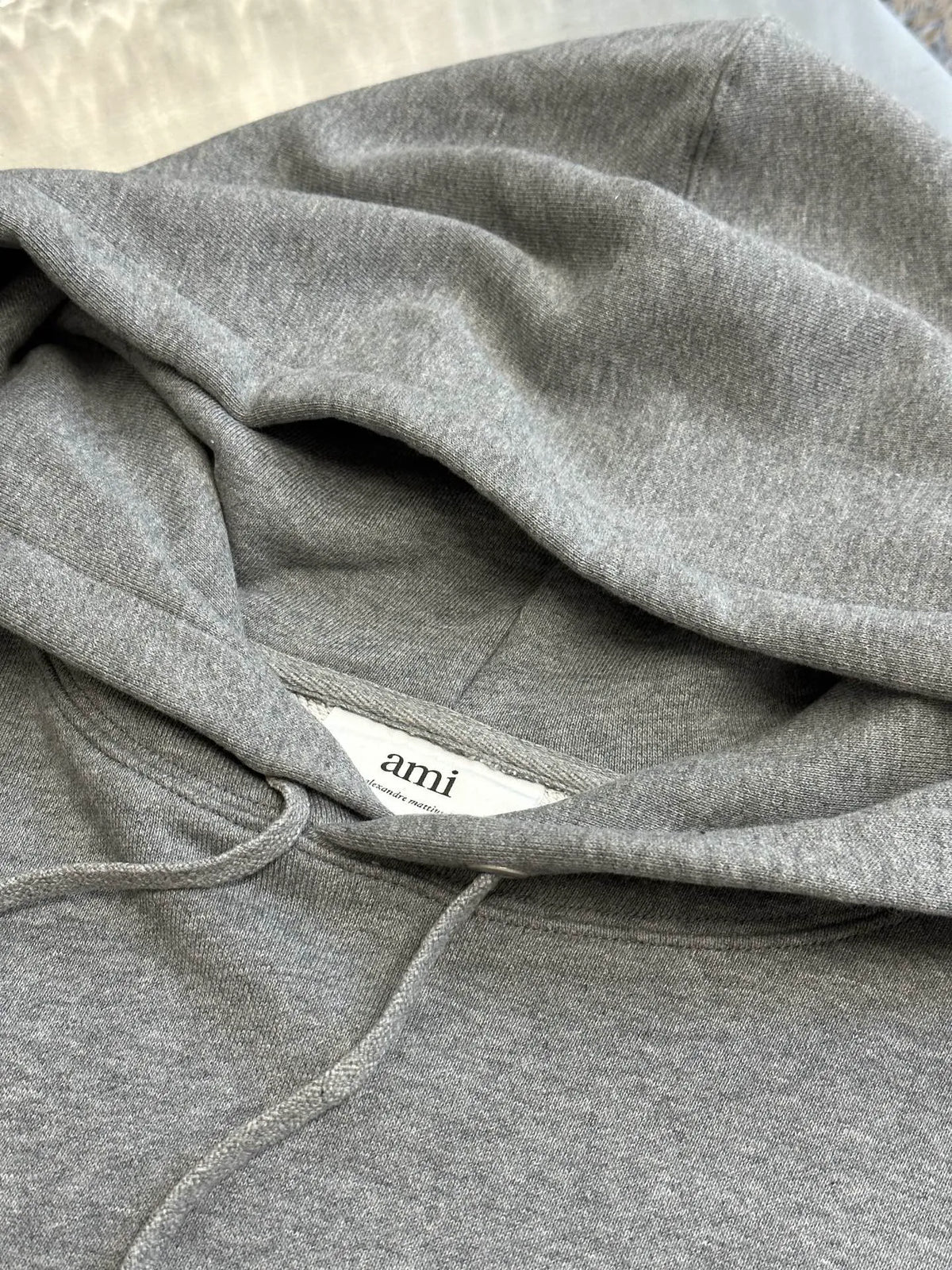 Gray hoodie fabric close-up with drawstring and soft knit texture