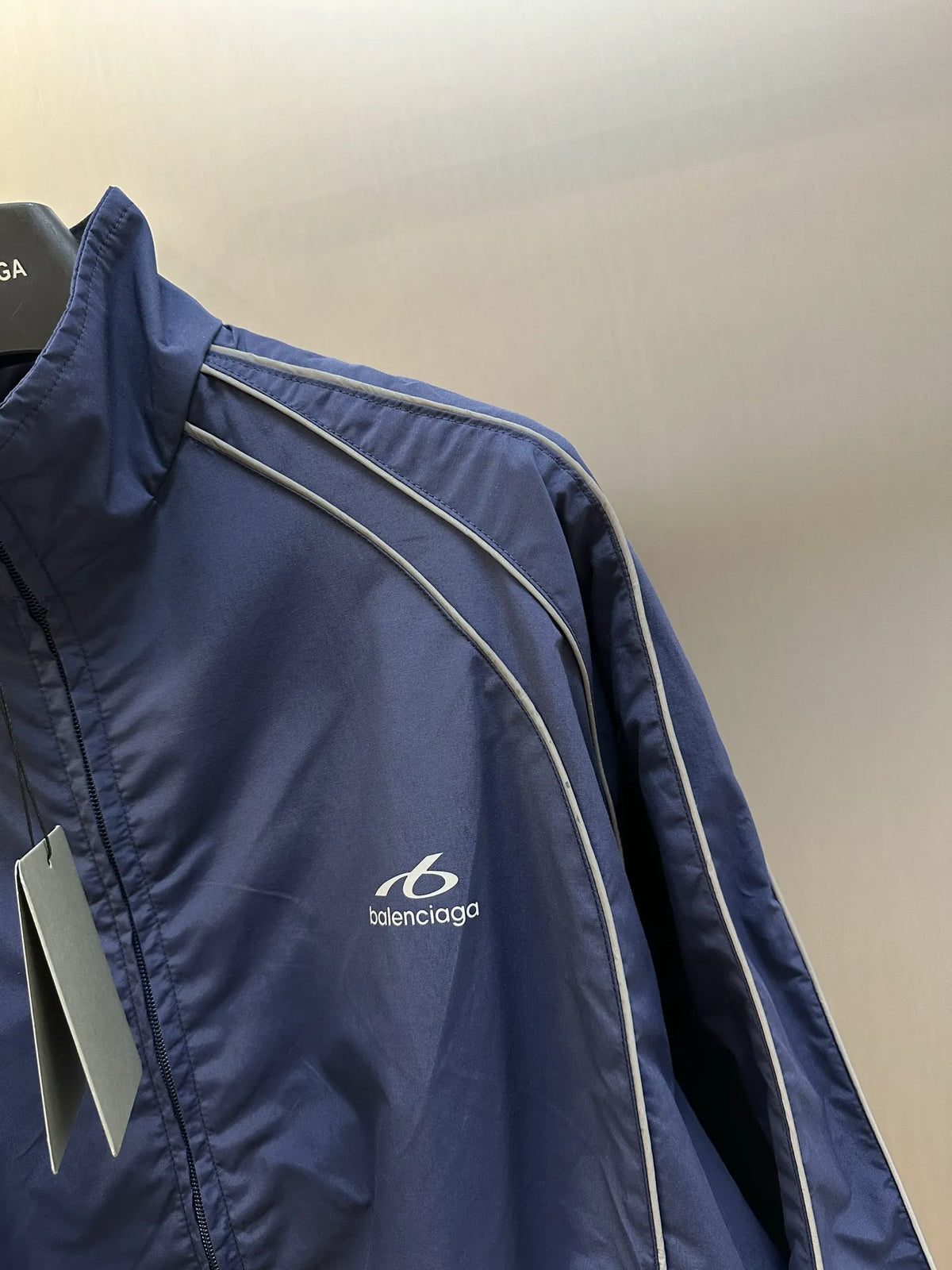 Navy jacket side panel with white track stripe piping and Balenciaga logo