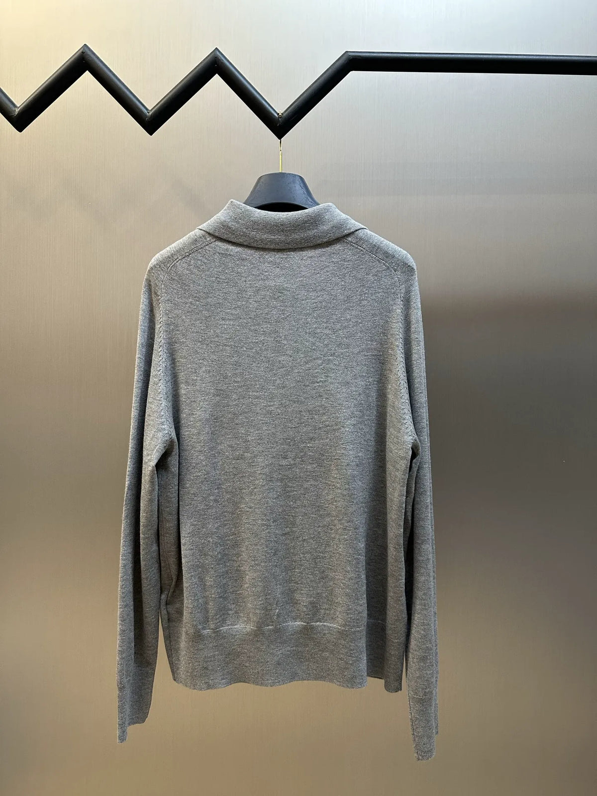 Gray knit long-sleeve polo sweater with ribbed cuffs, back view