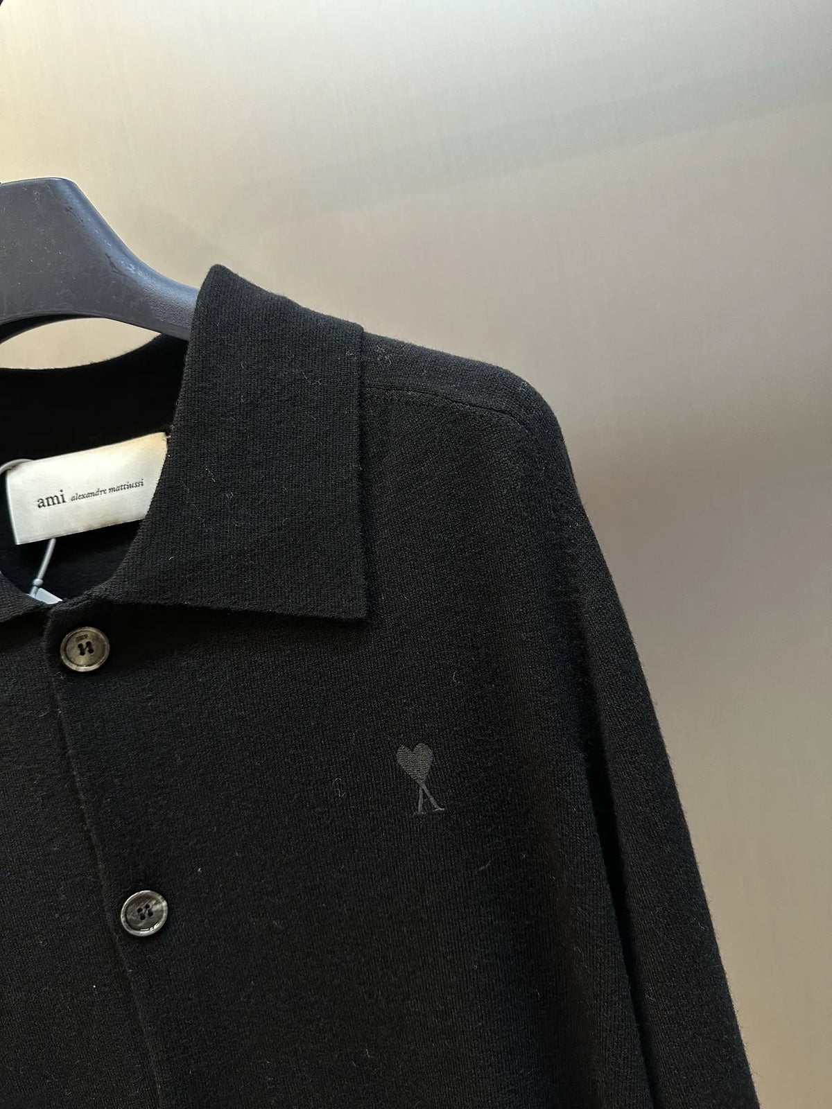 Amiri black coat chest logo and metal front buttons on knit placket
