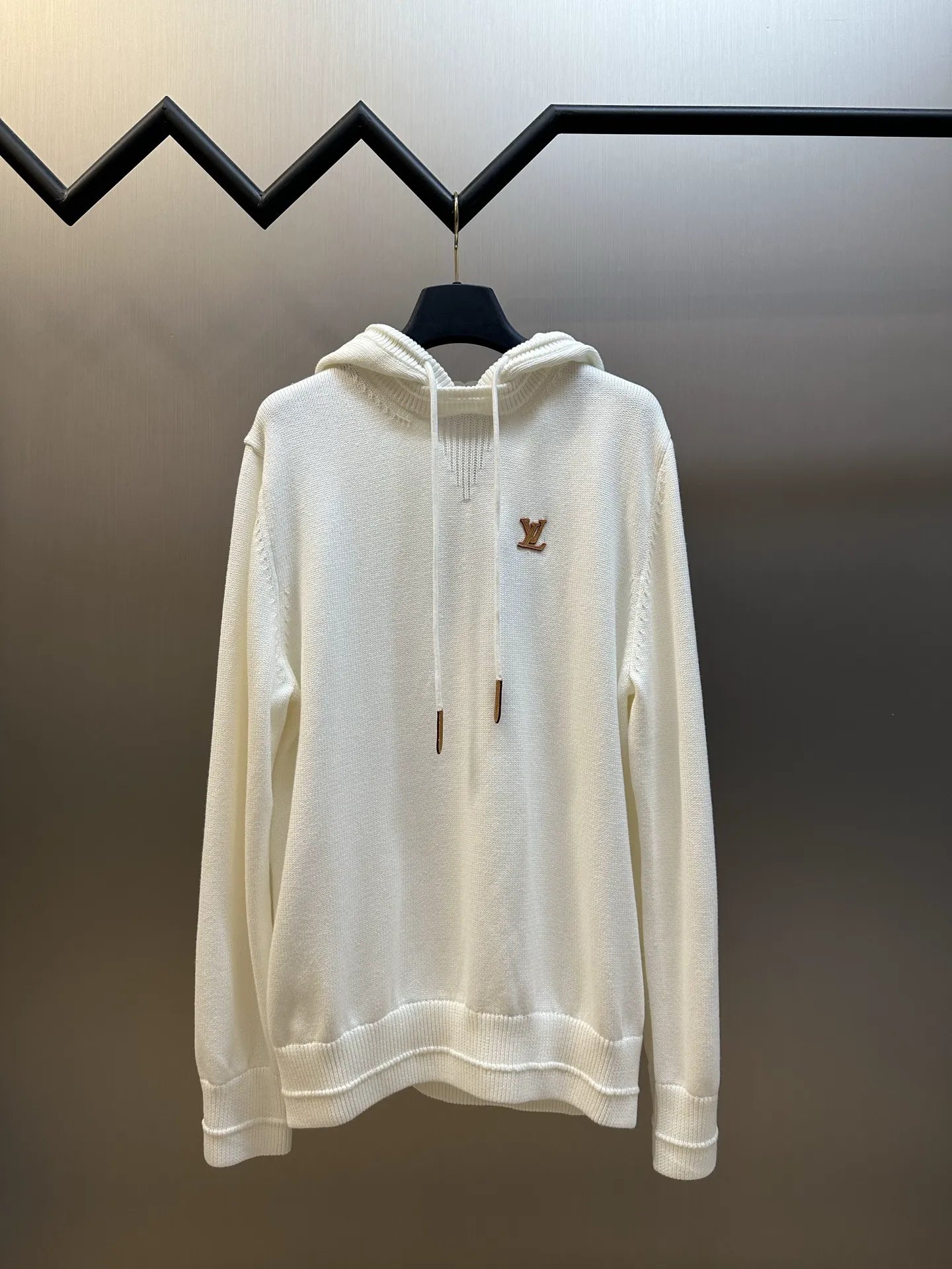 Cream long-sleeve hoodie with front pocket and brown LV logo on chest