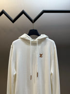 Cream long-sleeve hoodie with hood and brown LV logo on the upper chest