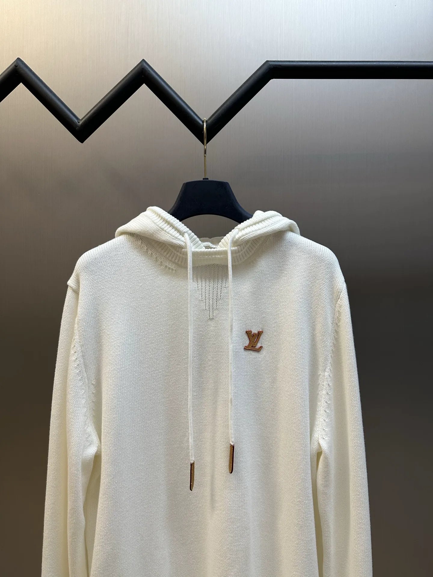 Cream long-sleeve hoodie with hood and brown LV logo on the upper chest