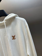 Cream hoodie with hood and small brown LV logo, close view of the shoulder area