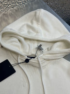 Cream knit hoodie with drawstring hood and interior black tag