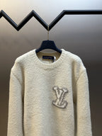 Off-white long-sleeve crewneck sweater with dark LV-style logo at center front
