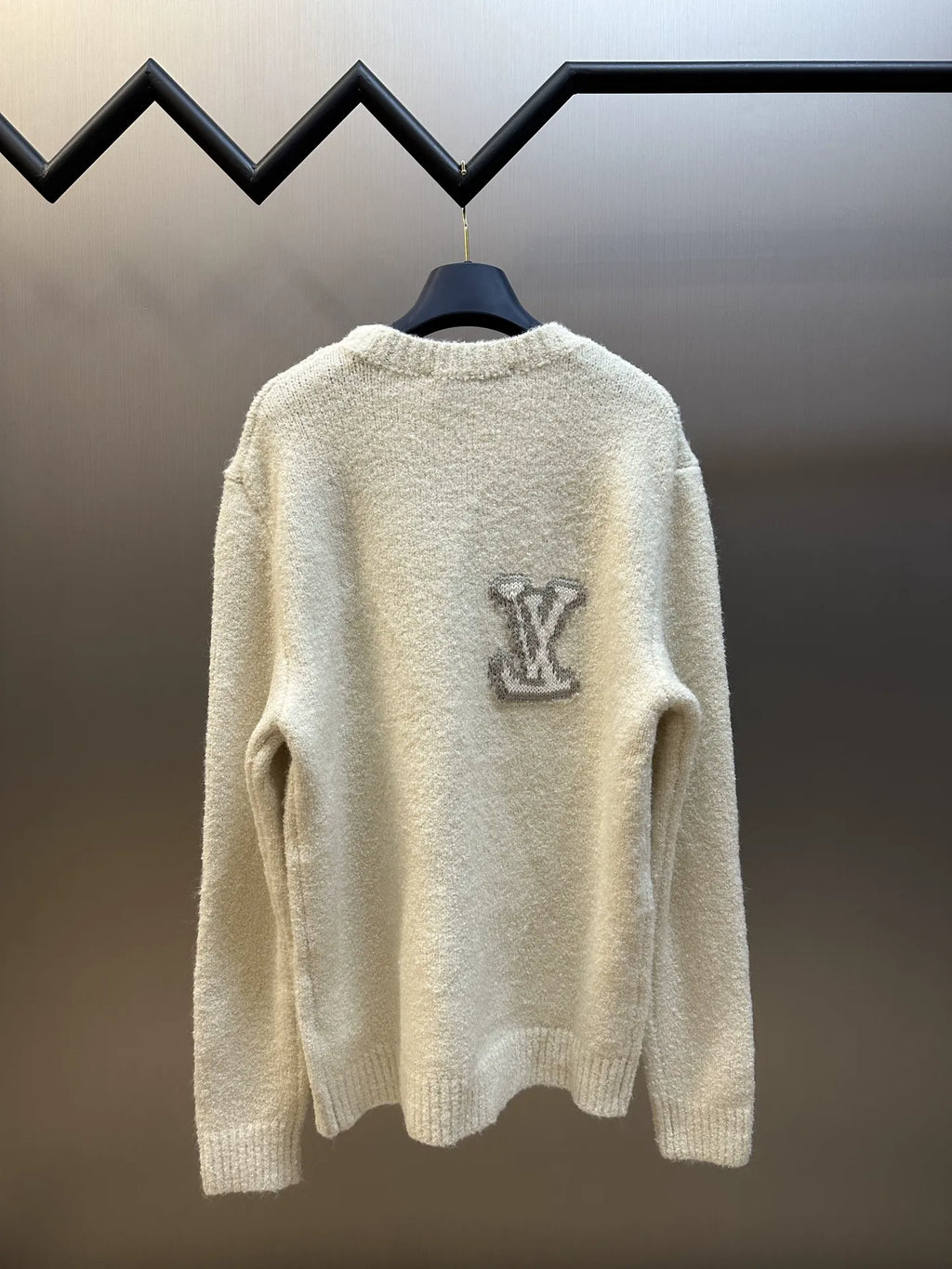 Off-white long-sleeve sweater with LV-style monogram on the back yoke