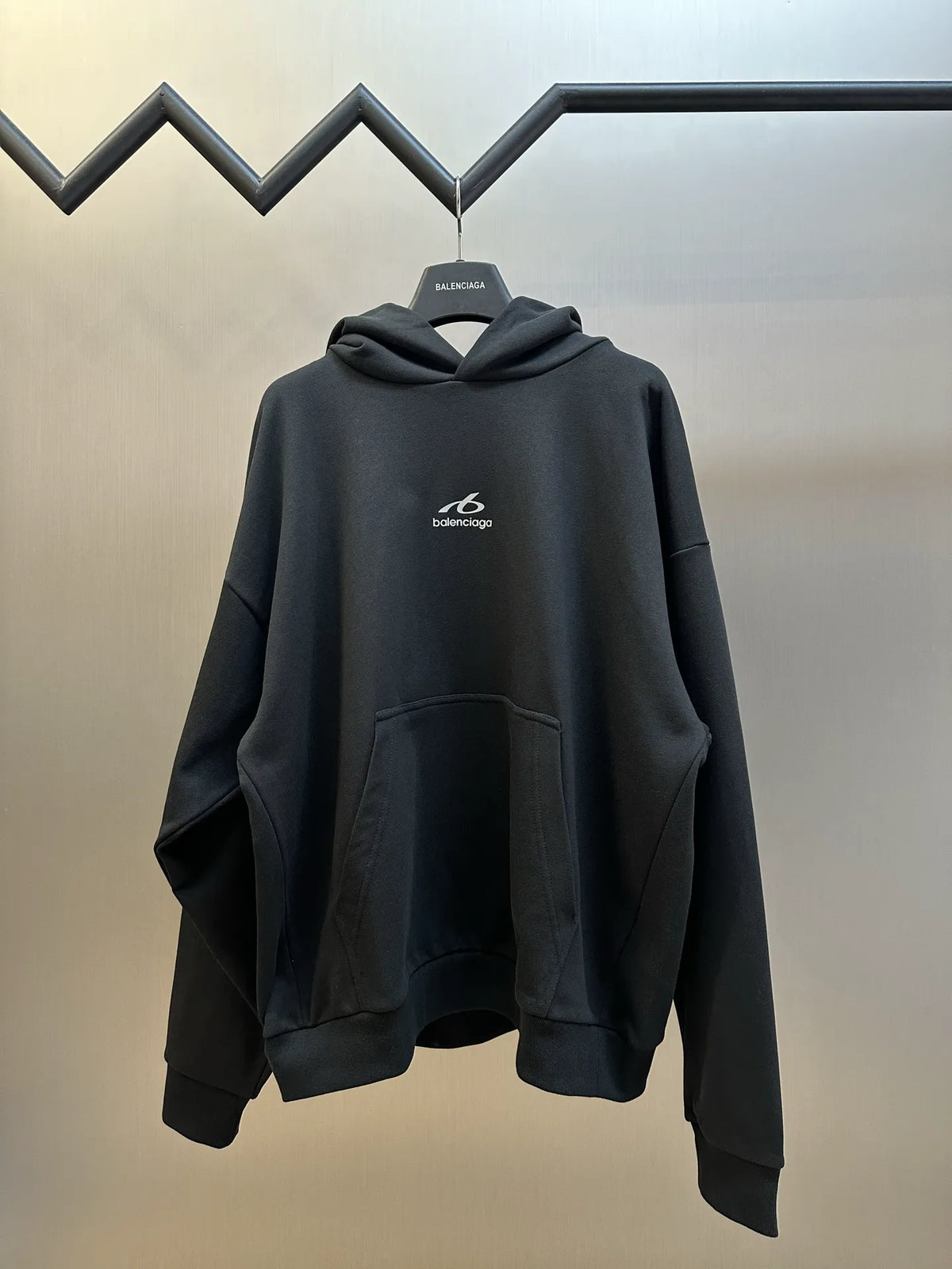 Black Balenciaga long hoodie with front pouch pocket and draped sleeves