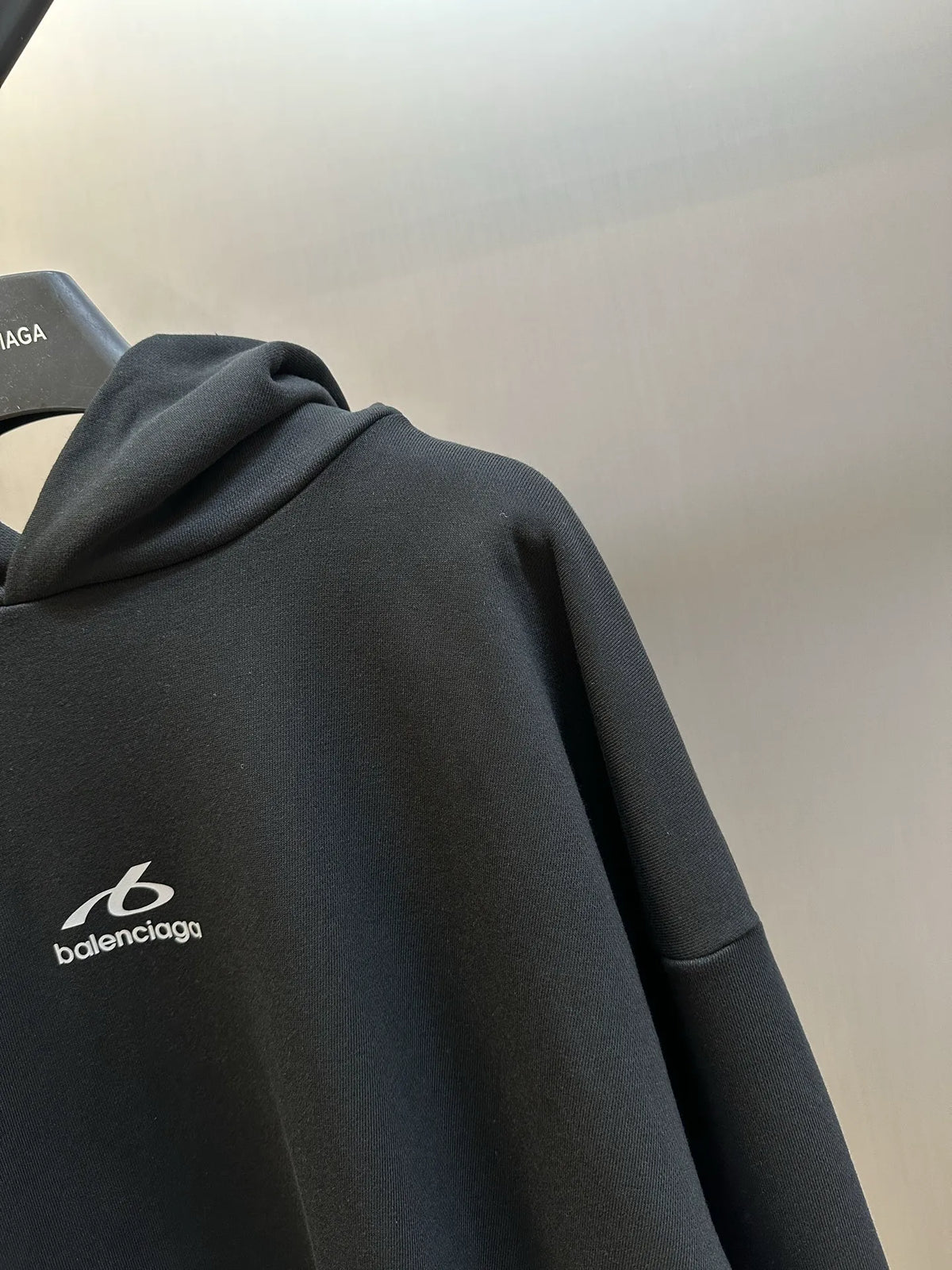 Black Balenciaga hoodie front with small logo on chest