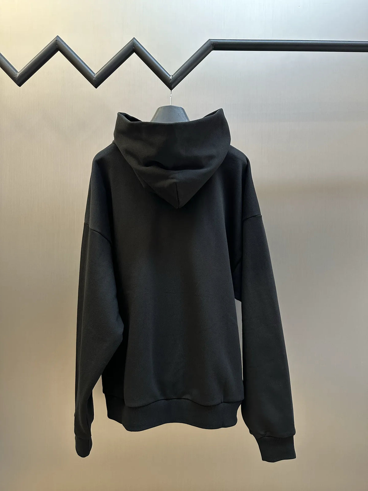 Black Balenciaga long hoodie, back view with hood and ribbed cuffs