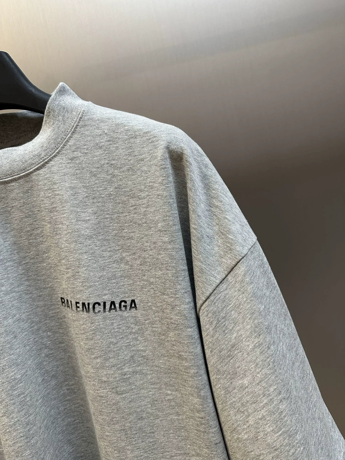 Light gray crew-neck T-shirt with 'BALENCIAGA' logo text on the front near shoulder