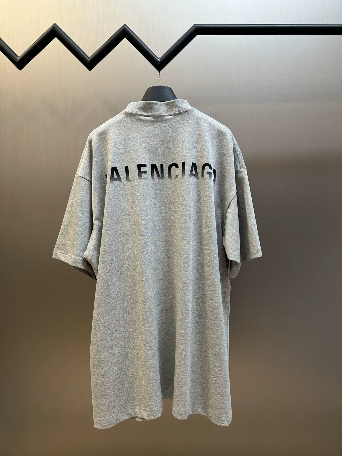Light gray backless? no—light gray crew-neck T-shirt, large 'BALENCIAGA' on back