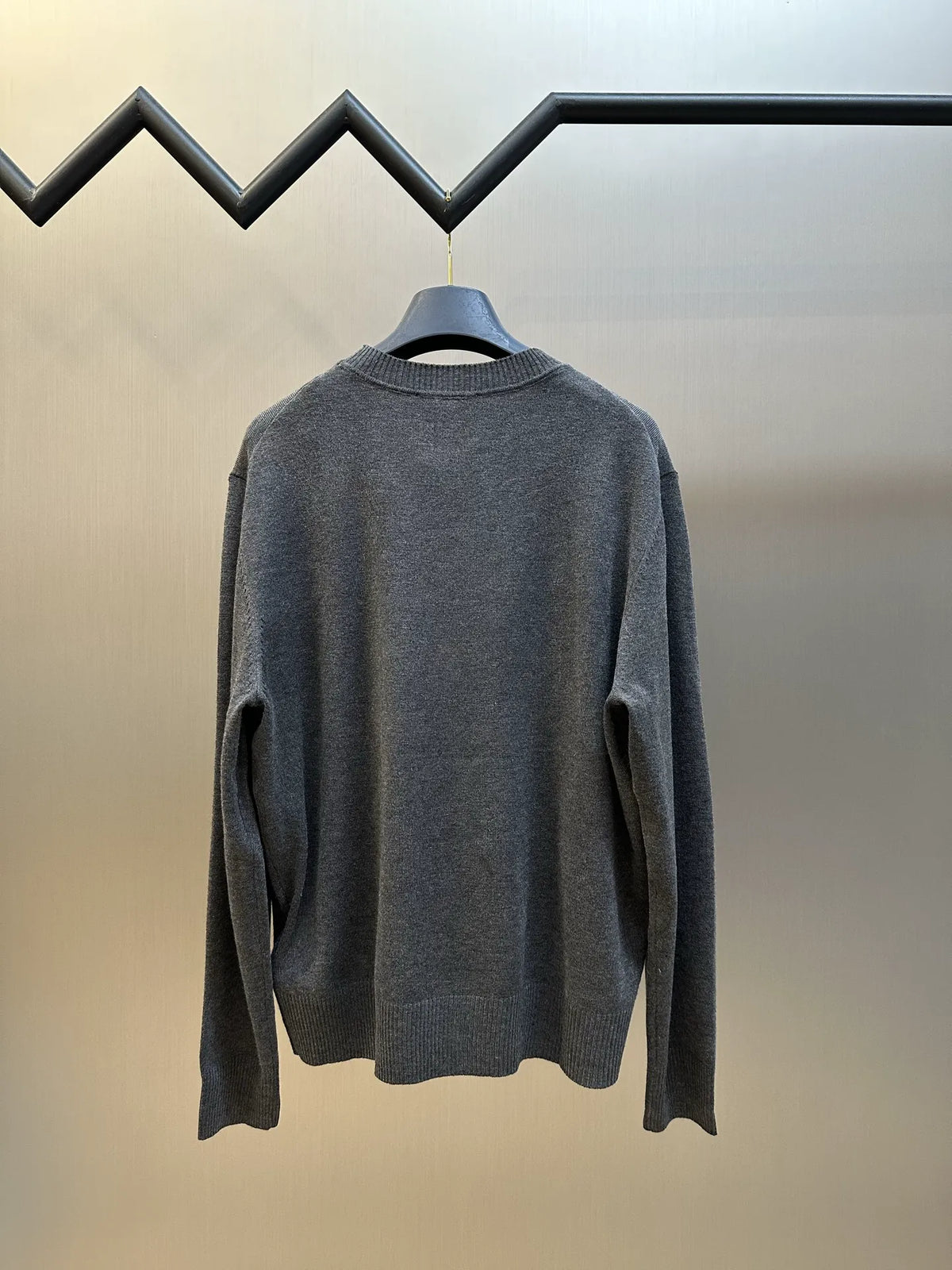Back view: dark gray crewneck knit sweater with ribbed cuffs and hem