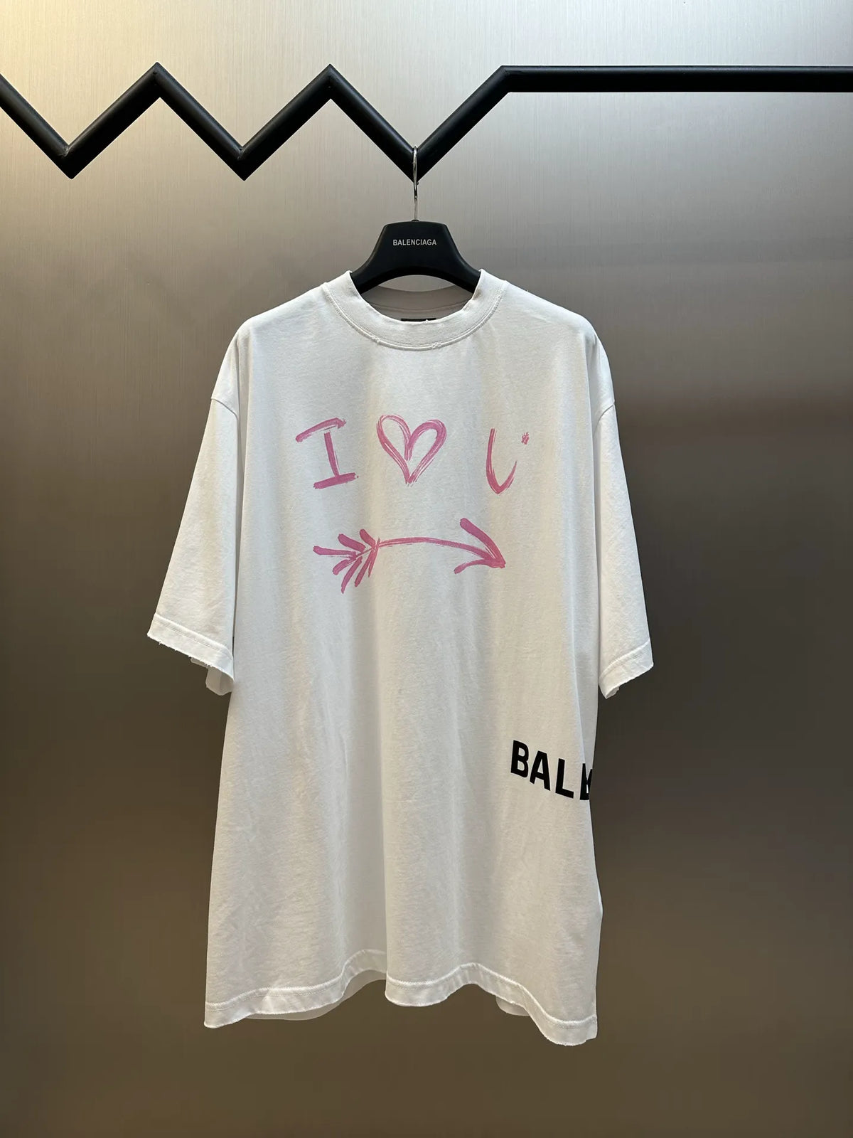 Balenciaga white crewneck T-shirt with pink heart-and-arrow graphic and black side logo