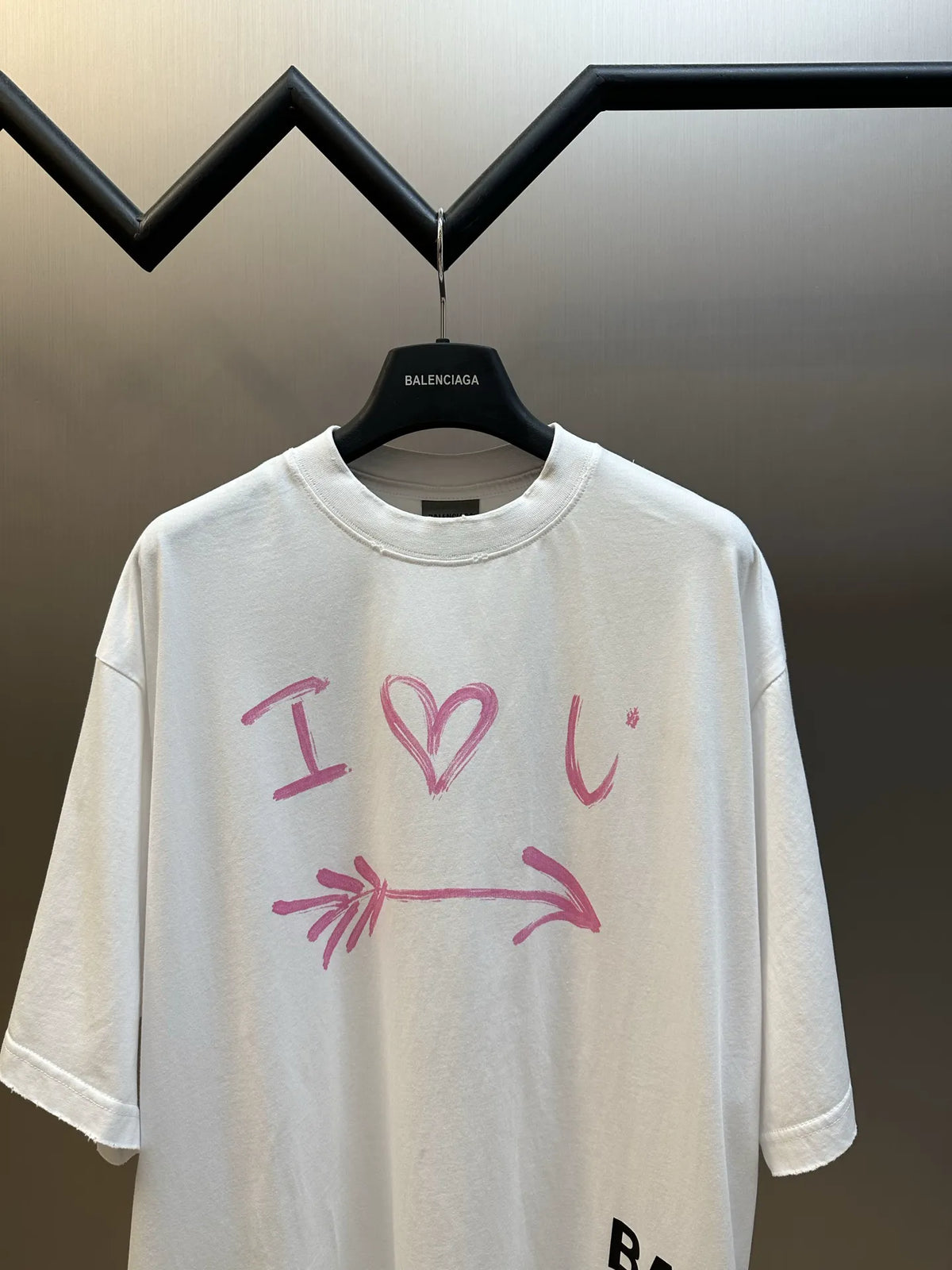 Balenciaga white crewneck T-shirt with pink heart-and-arrow graphic, short sleeves
