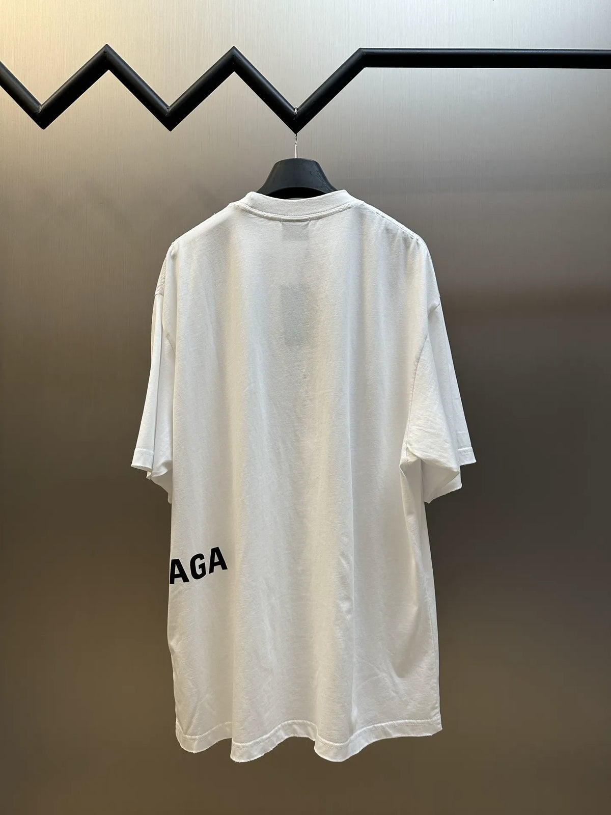 Balenciaga white T-shirt with black logo text at hem, short sleeves