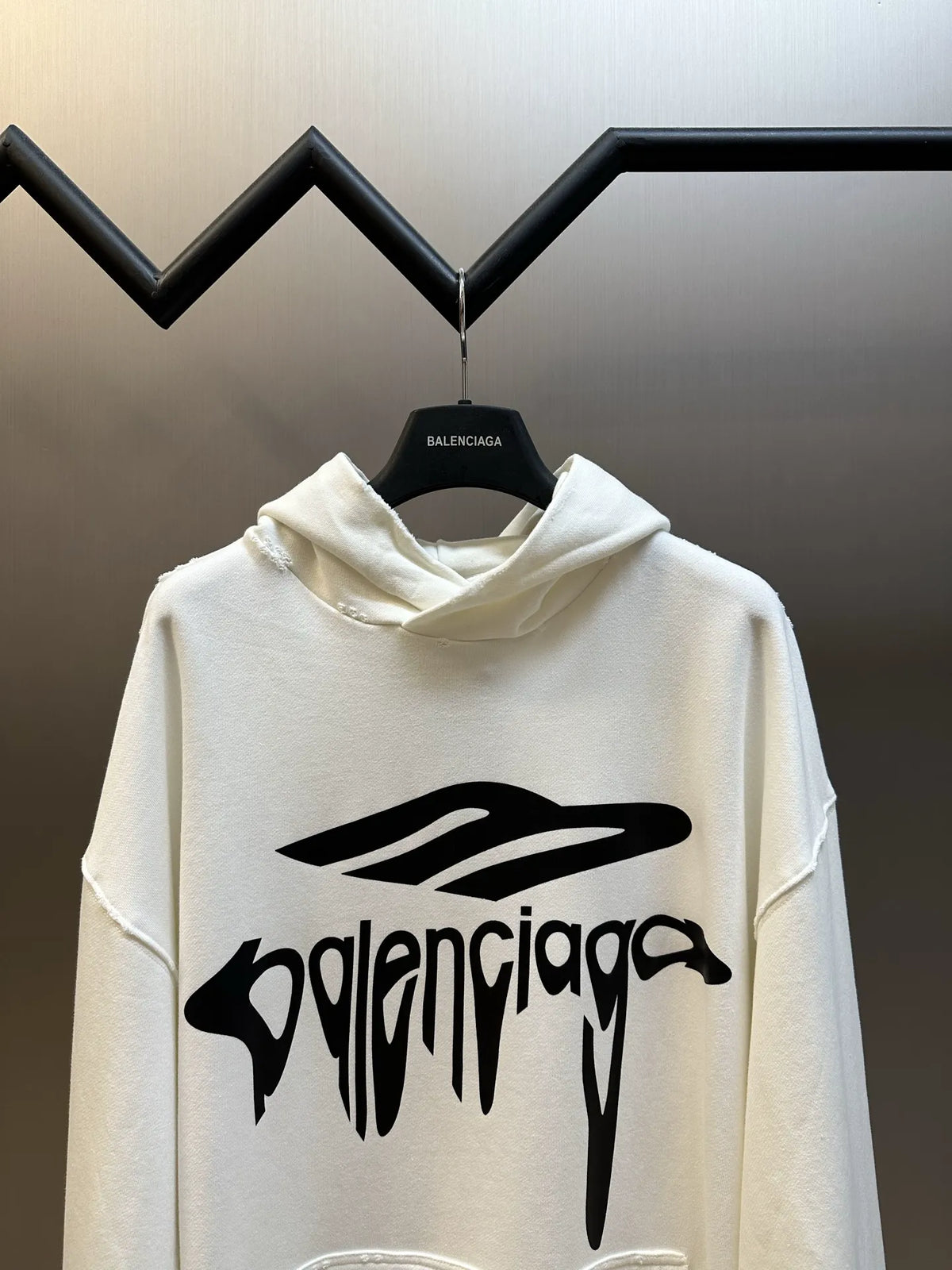 White long-sleeve hoodie with large front Balenciaga-style logo and hood