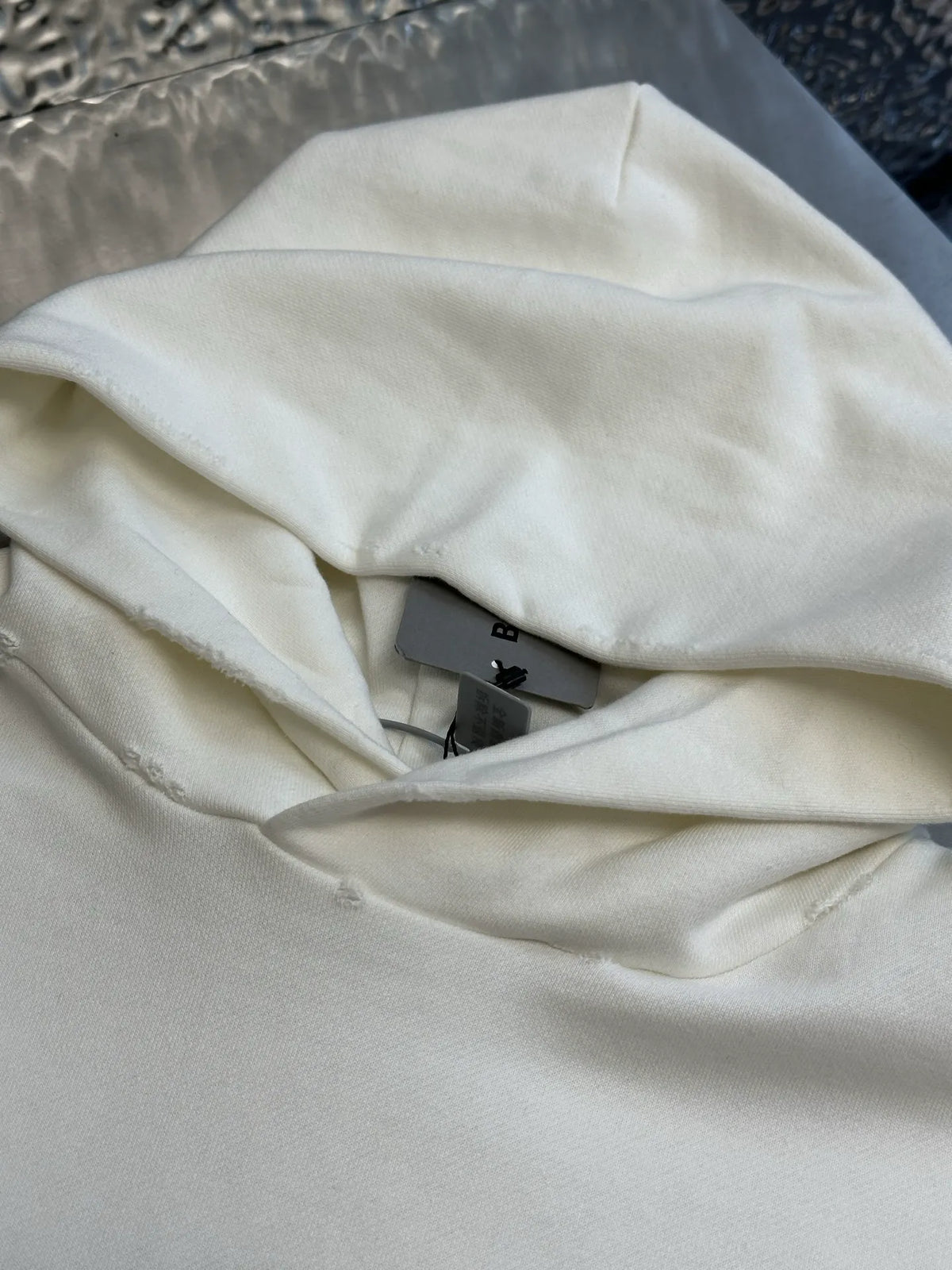 White hoodie fabric and hood lining with visible inside label