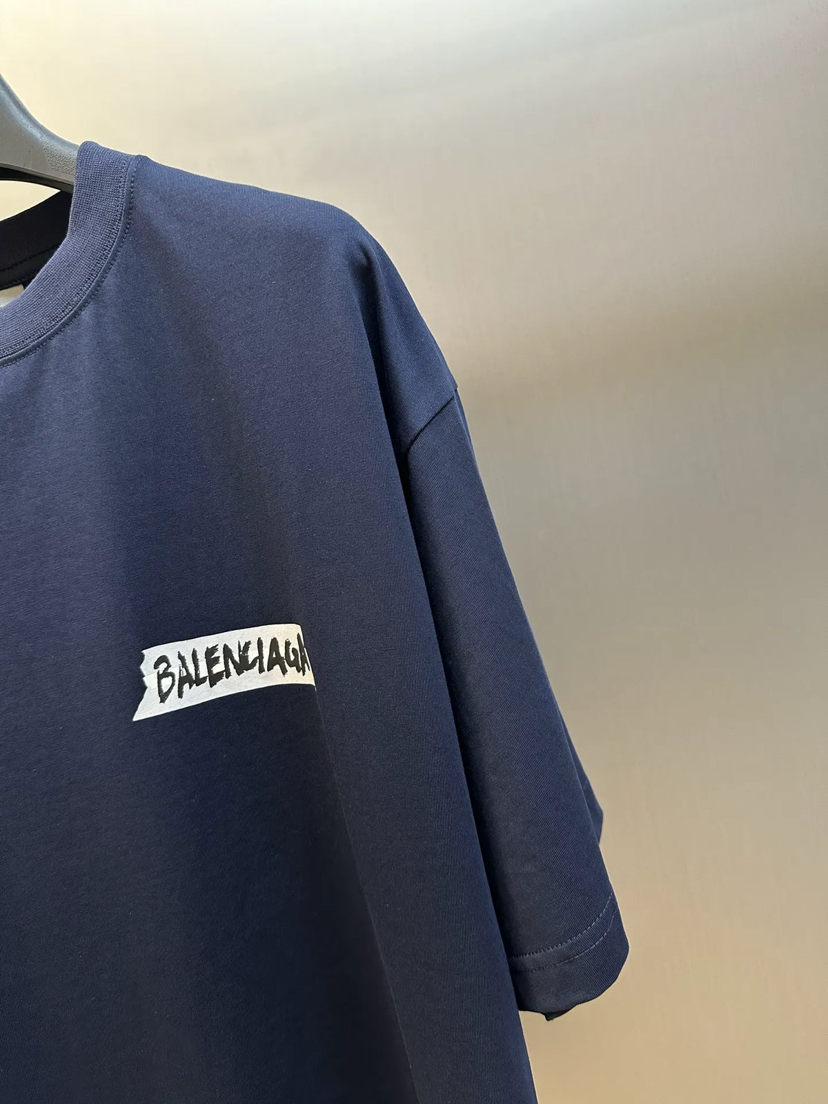 Navy Balenciaga T-shirt sleeve detail with small logo print