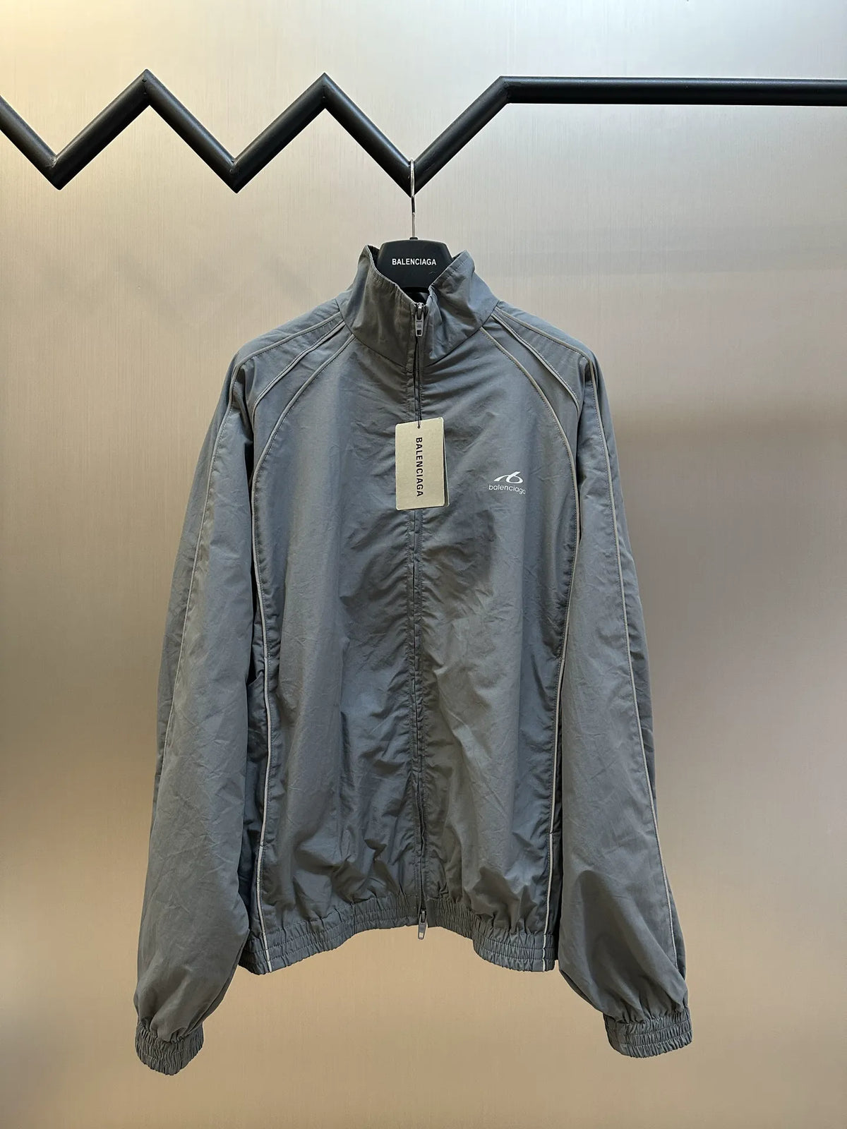Light blue-gray zip-up jacket with stand collar and elastic cuffs