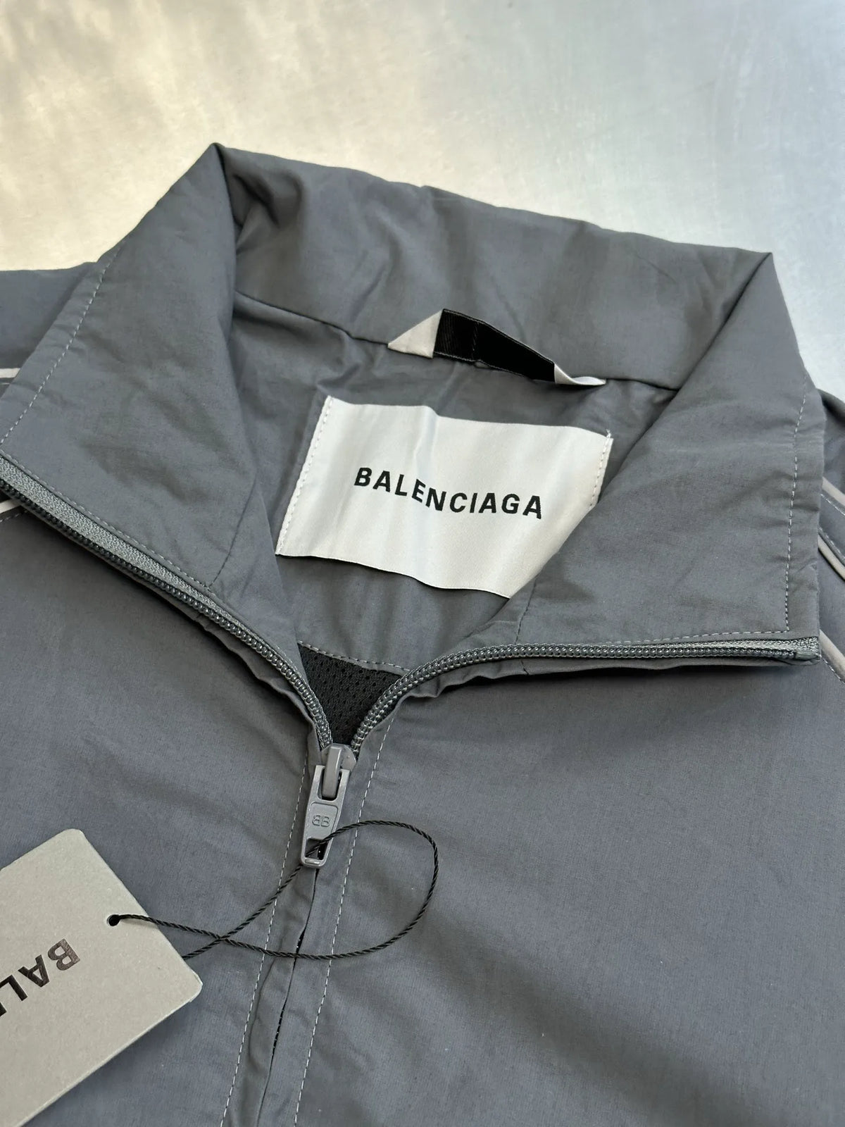 Light blue-gray jacket collar and zipper with Balenciaga logo label