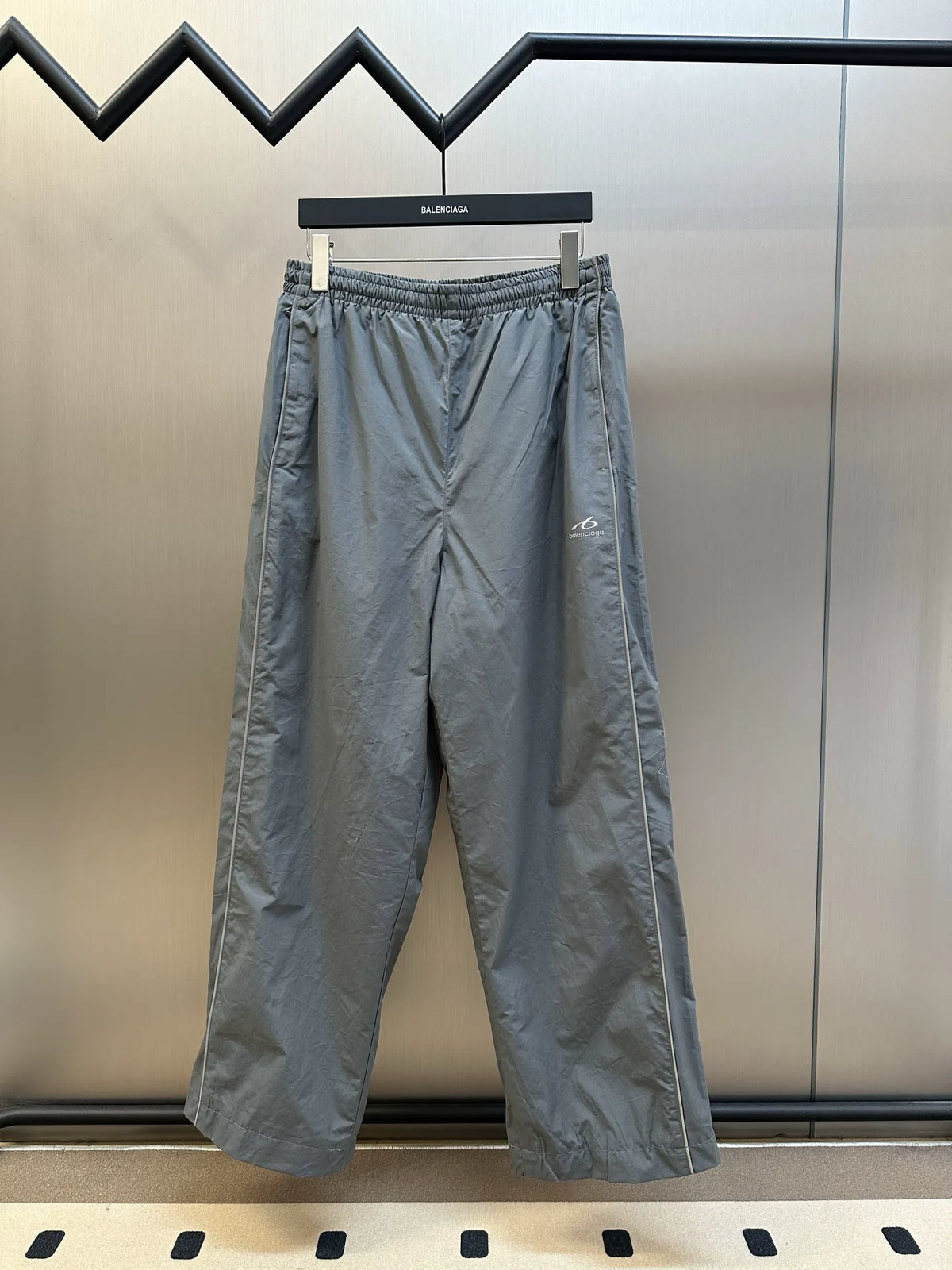 Light gray Balenciaga pants with elastic waistband and relaxed wide-leg fit