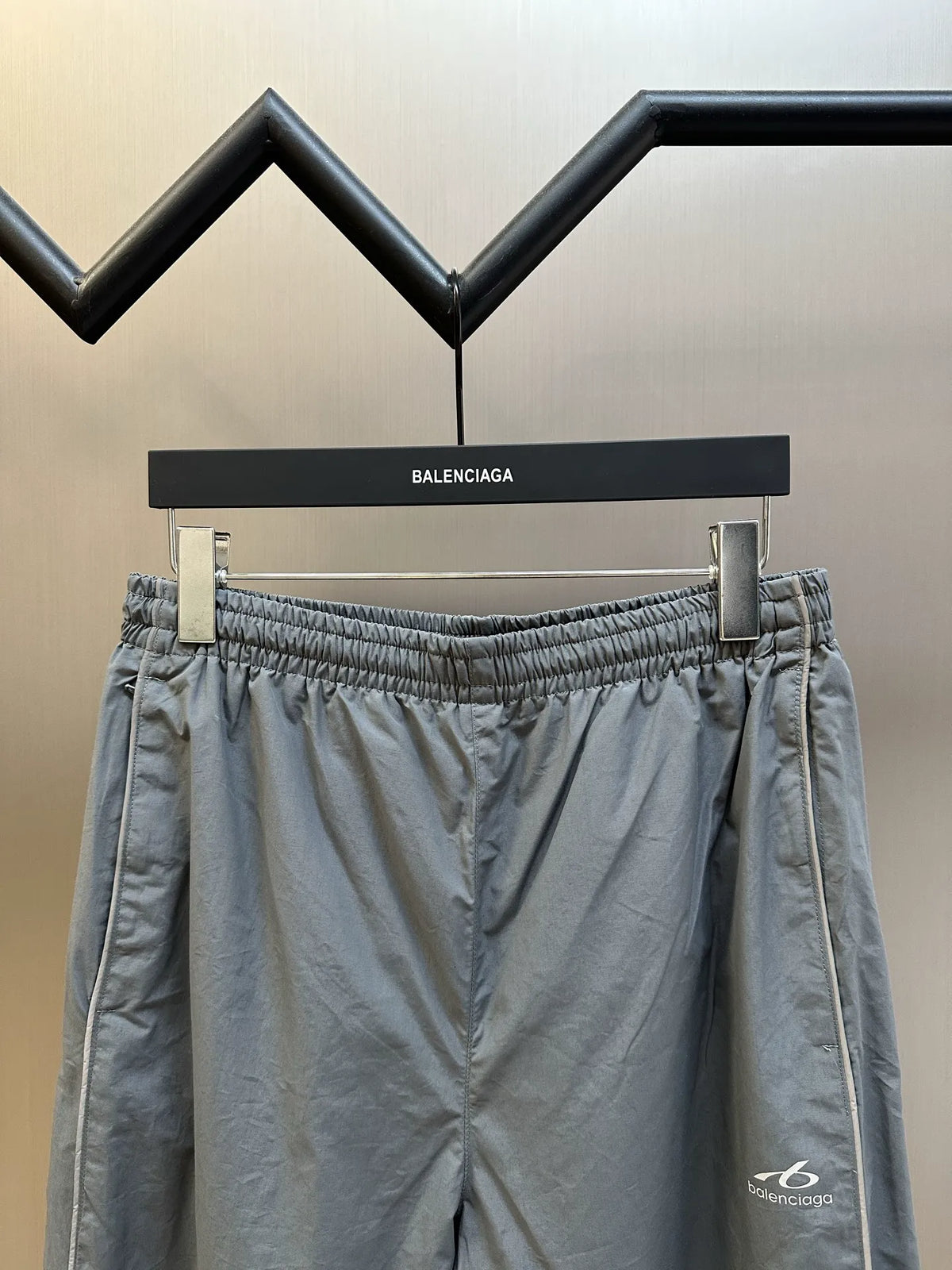 Light gray Balenciaga pants front view with elastic waistband and drawstring cord