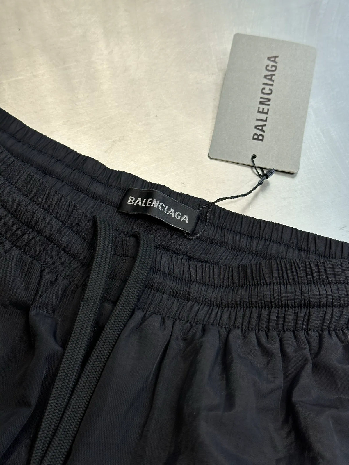 Balenciaga shorts waistband close-up with drawcord and Balenciaga label