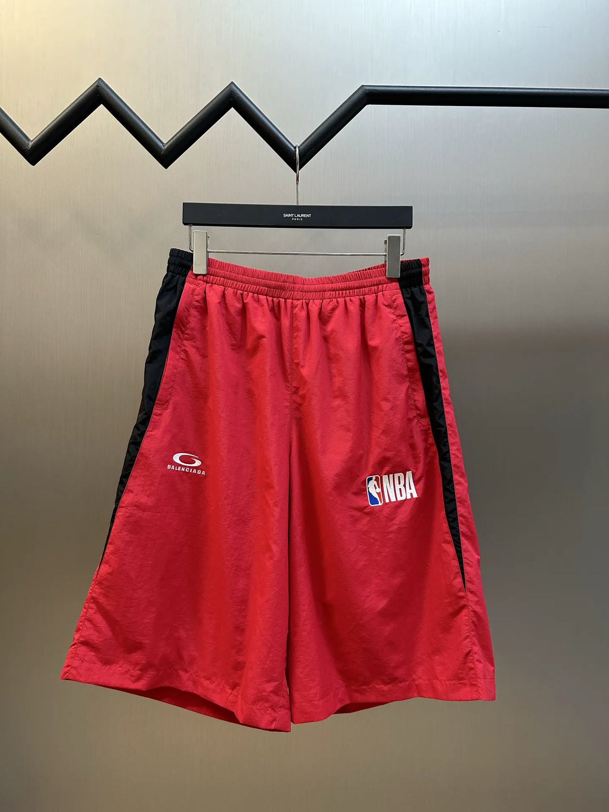 Balenciaga red basketball shorts with elastic waistband and black side stripe, NBA logo
