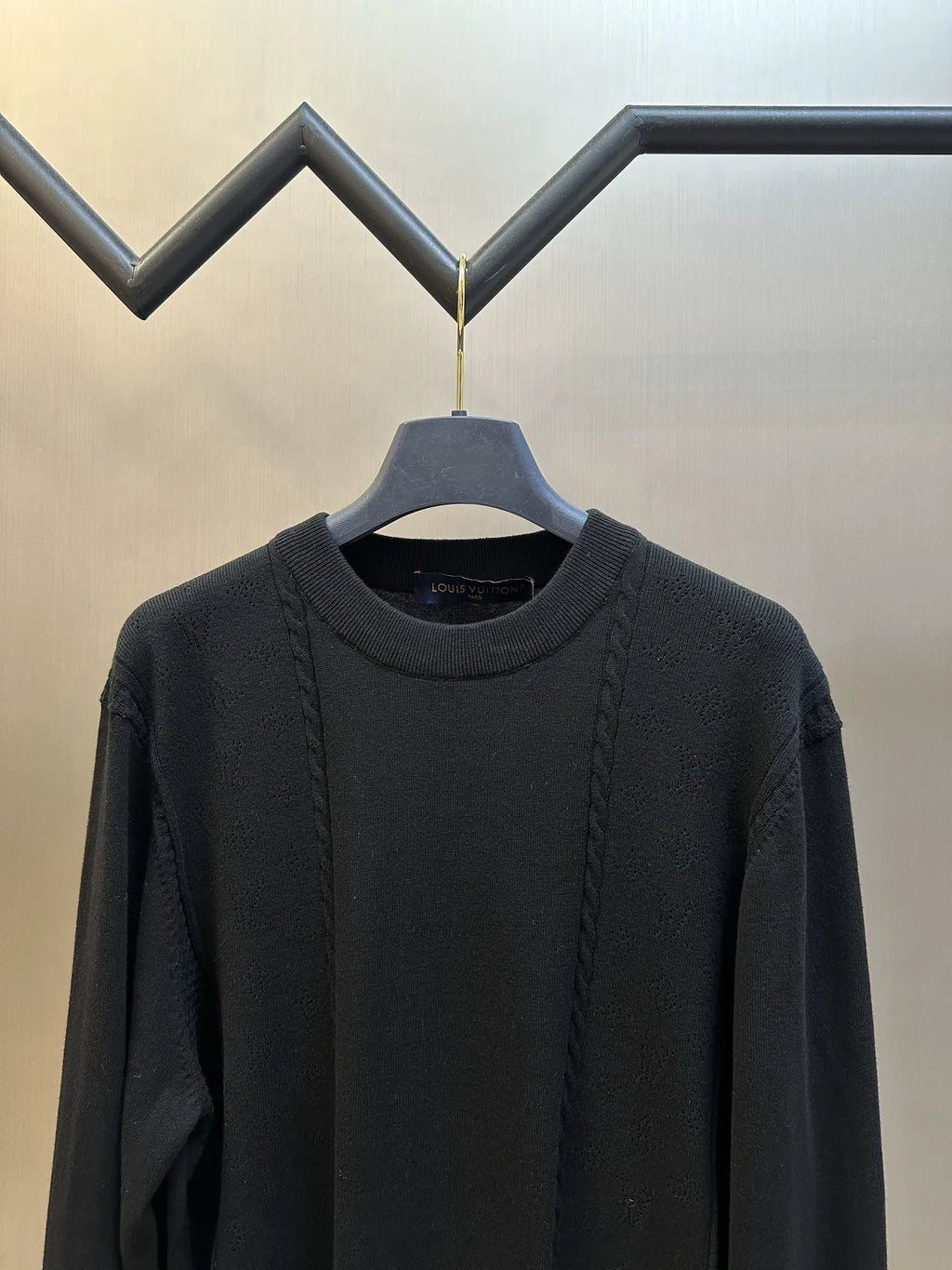 Black long-sleeve crew-neck sweater with vertical textured knit panels