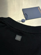 Black sweater with Louis Vuitton logo patch at the hem