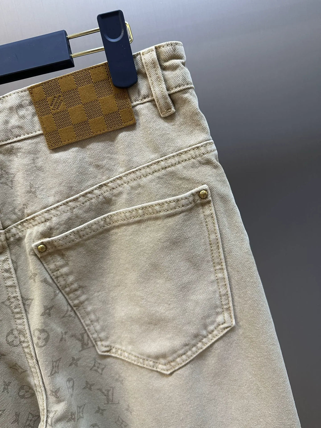 Light beige LV monogram pants, front pocket detail with stitched seams