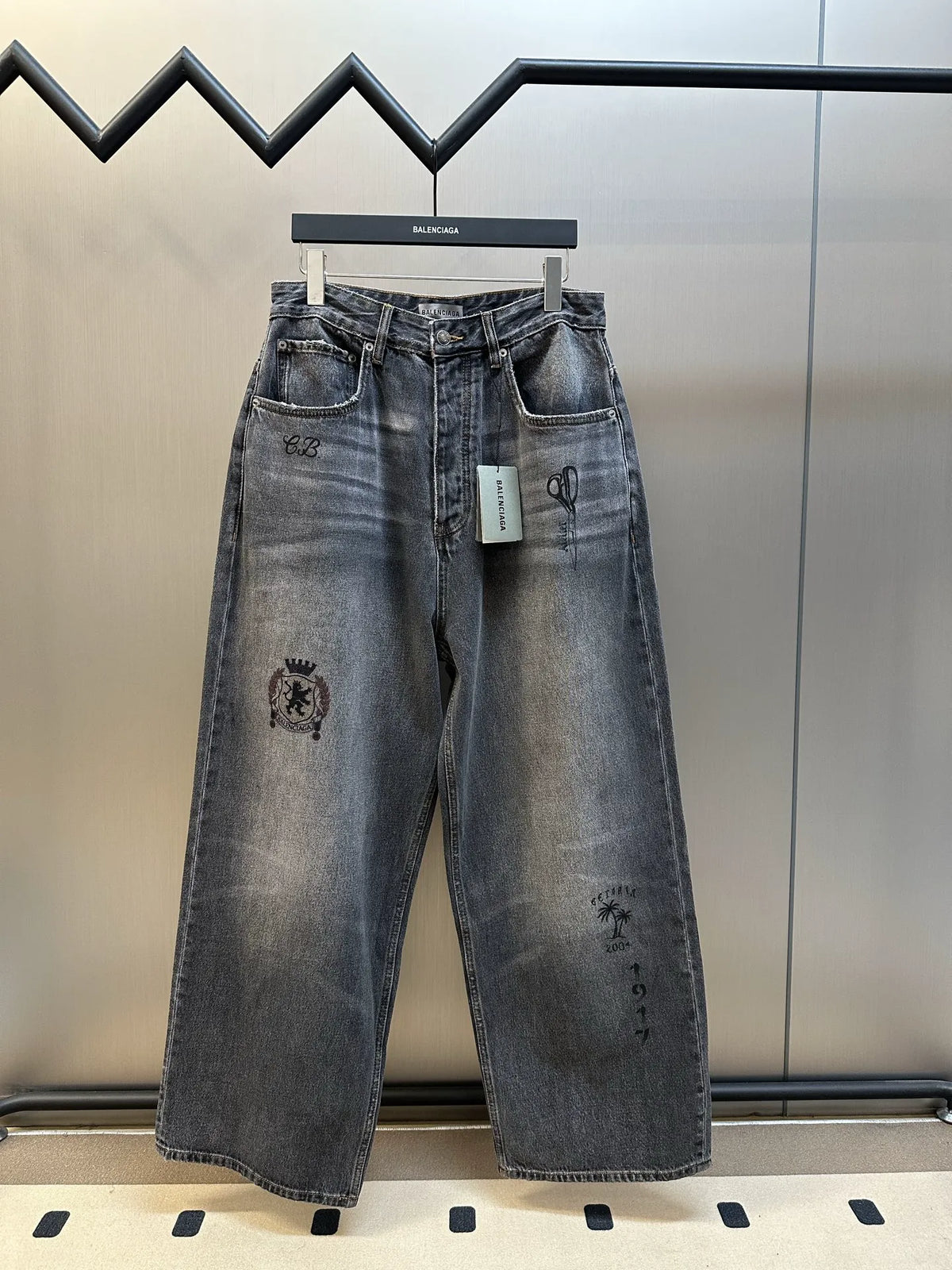 Balenciaga dark blue denim wide-leg pants with graphic patches and belt loops