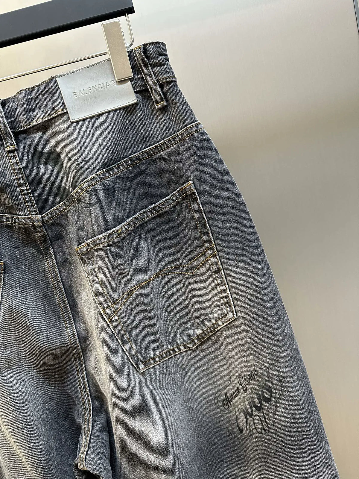 Balenciaga dark blue denim jeans with contrast-stitched pocket and embroidered motifs