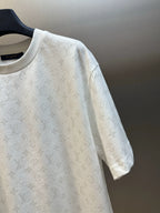 White short-sleeve T-shirt with all-over monogram pattern, close-up sleeve view