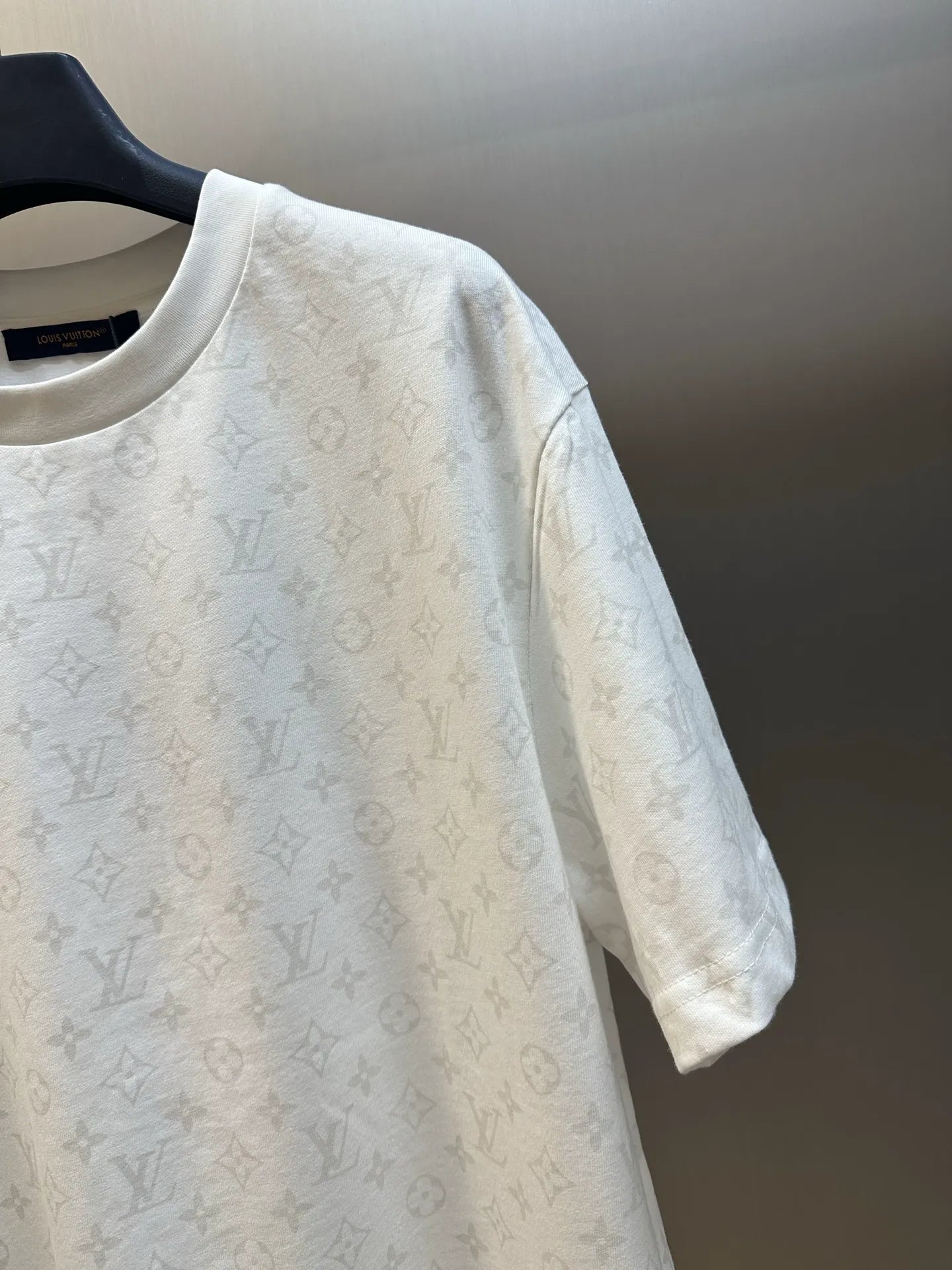 White short-sleeve T-shirt with all-over monogram pattern, close-up sleeve view