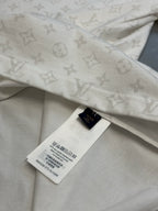 T-shirt hem with size tag and repeating monogram pattern