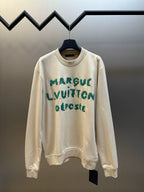 Cream long-sleeve sweatshirt with green LV-style graphic print, crew neck.