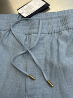 Light blue shorts with drawstring and elastic waist, inside ties visible