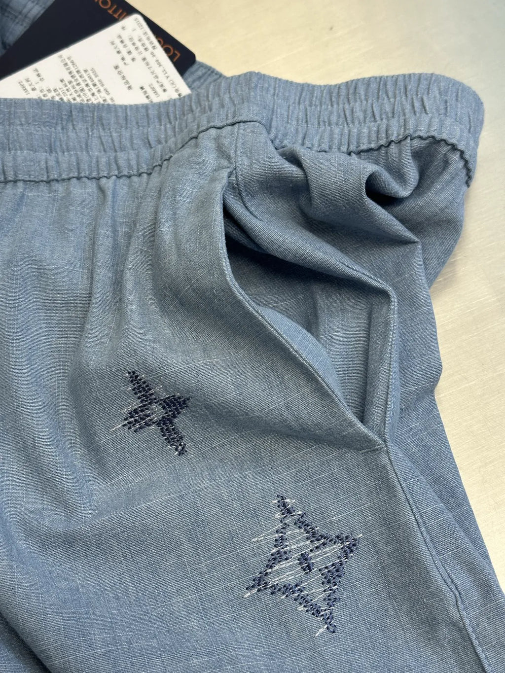 Light blue shorts close-up of waistband and drawstring bow