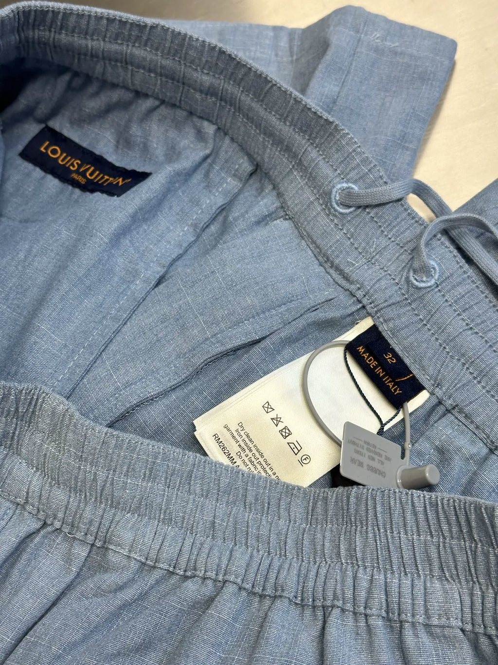 Light blue shorts inside label area, elastic waistband and drawcord with tags
