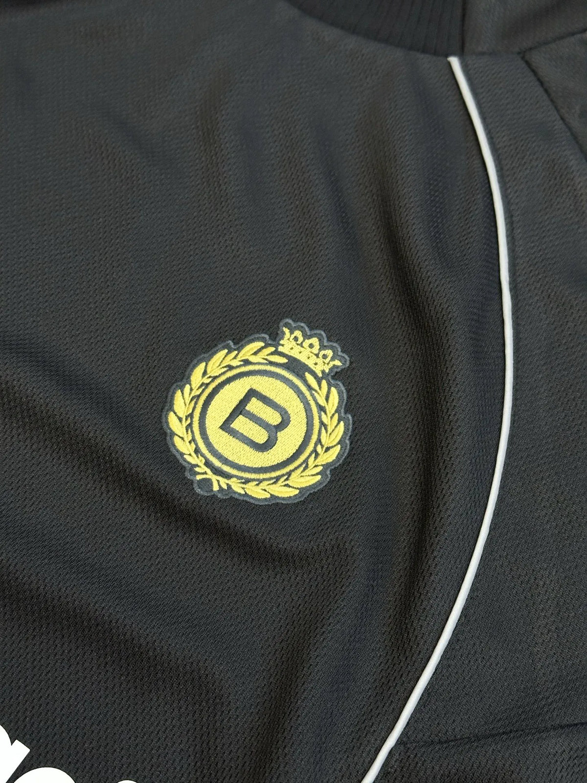 Black Balenciaga crest emblem patch on the chest of an athletic jersey