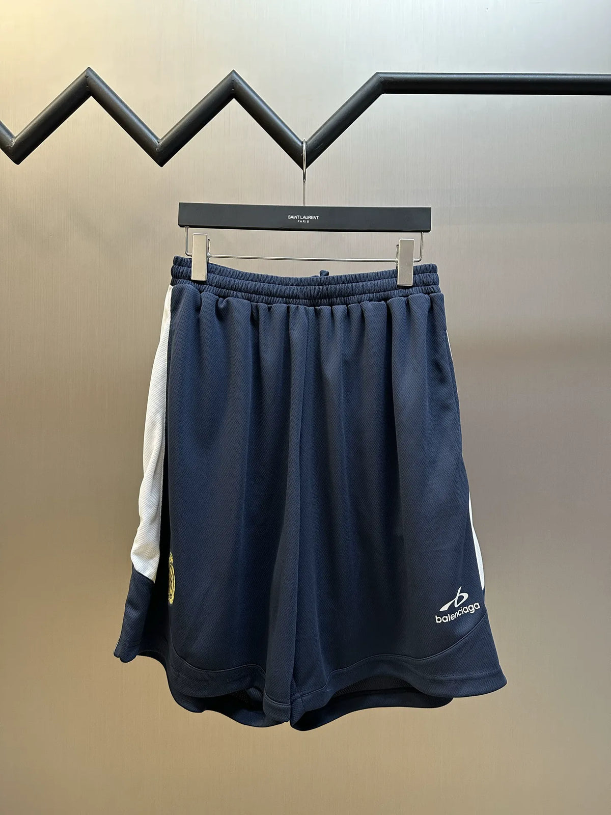 Navy elastic-waist shorts with drawstring and Balenciaga logo patch at hem