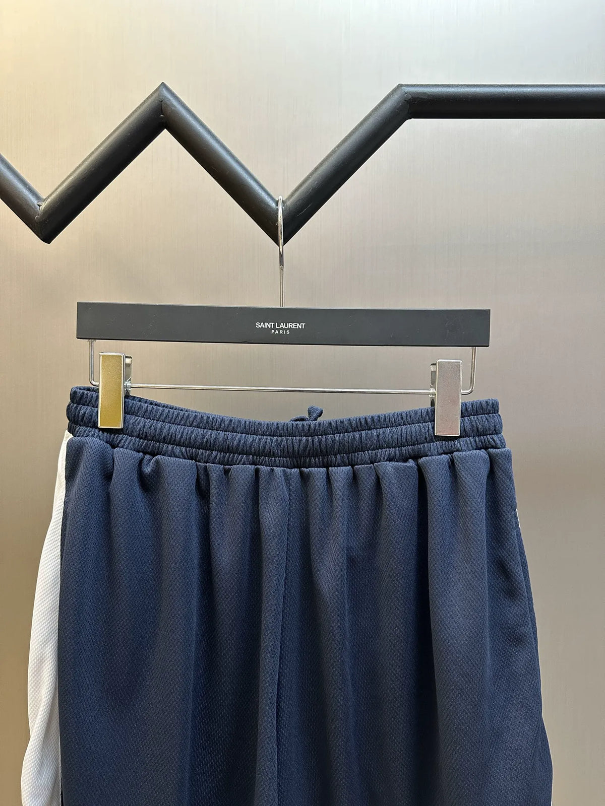 Navy elastic-waist shorts with textured fabric and subtle vertical paneling