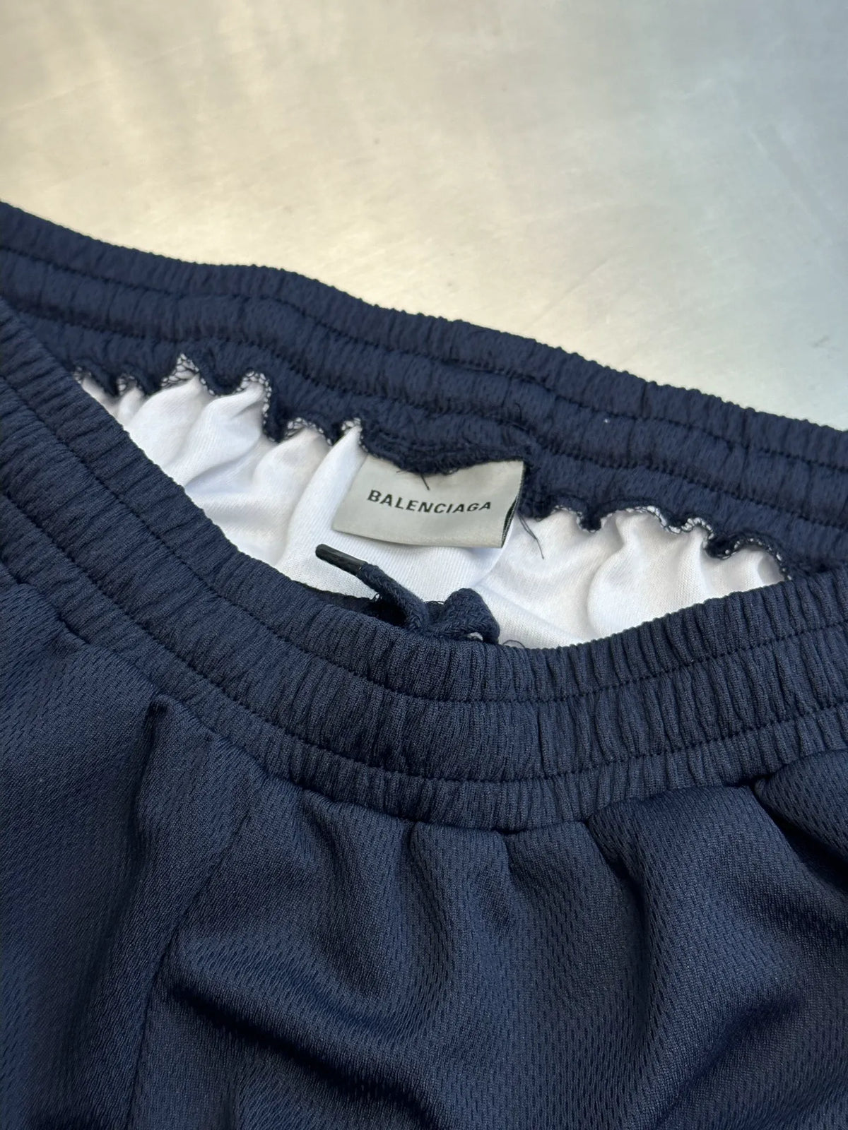 Navy elastic waistband with inner white label and woven brand tag